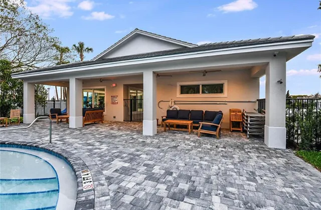 a view of a house with backyard porch and sitting area