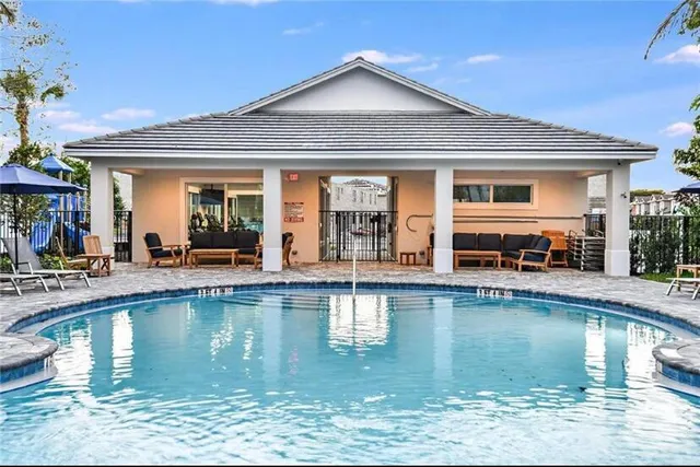 a view of a swimming pool with outdoor seating