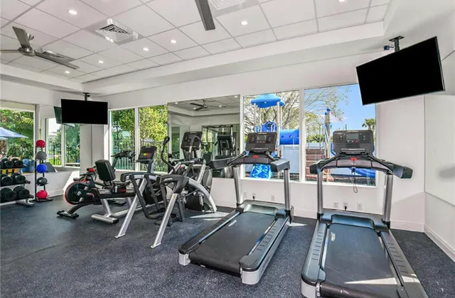 a room with gym equipment and a flat screen tv