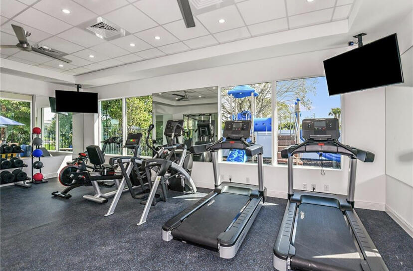 562 Parsons Way Deerfield Beach, FL 33442 - Photo 14 of 15 a room with gym equipment and a flat screen tv