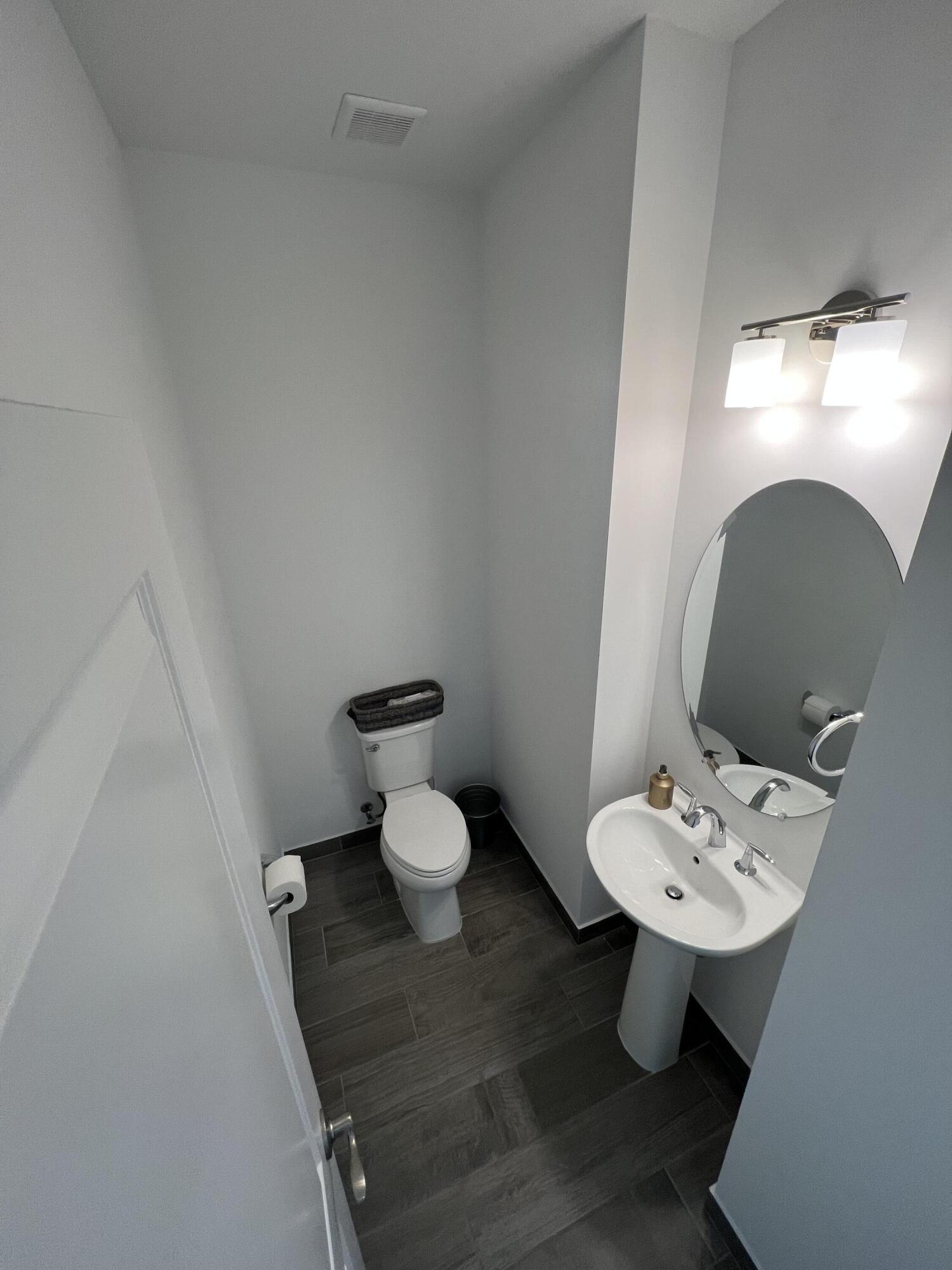 562 Parsons Way Deerfield Beach, FL 33442 - Photo 8 of 15 a bathroom with a toilet sink and mirror