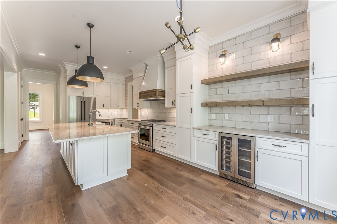 2707 North Otterdale Road Midlothian, VA 23113 - Photo 5 of 21 a kitchen with stainless steel appliances kitchen island granite countertop a stove a sink and a wooden floors