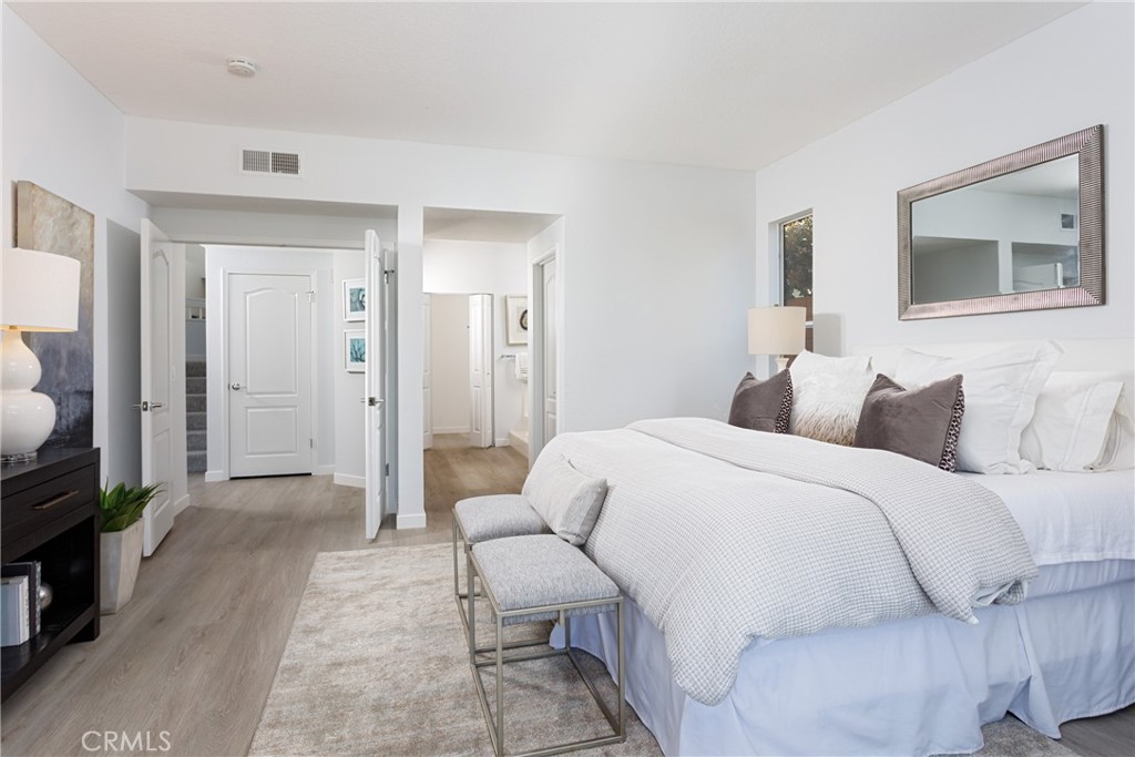 29672 Teracina Laguna Niguel, CA 92677 - Photo 12 of 35 a spacious bedroom with a bed a couch and a view of en suite bathroom