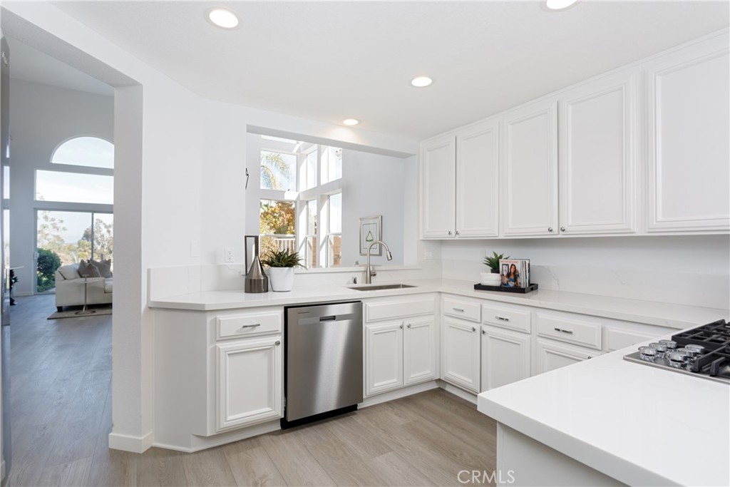 29672 Teracina Laguna Niguel, CA 92677 - Photo 9 of 35 a kitchen with a sink white cabinets and white appliances