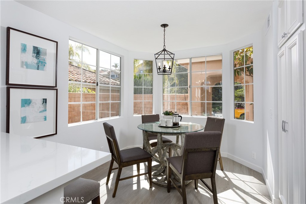 29672 Teracina Laguna Niguel, CA 92677 - Photo 10 of 35 a dining room with furniture a chandelier and wooden floor