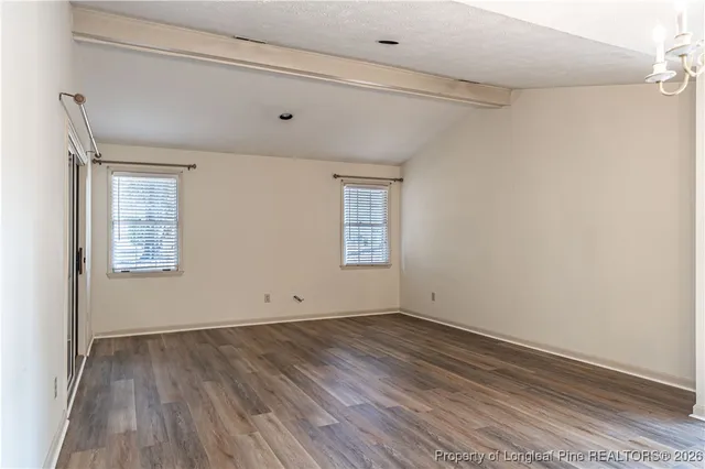 a view of room with wooden floor and fan