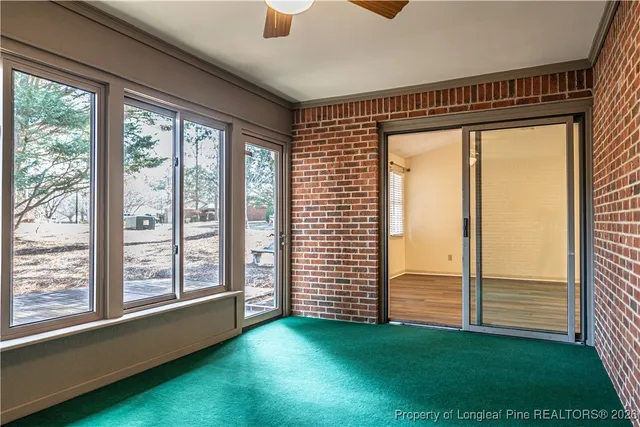a view of a room with window and a ceiling fan