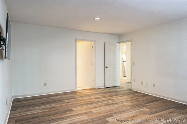 a view of an empty room and wooden floor