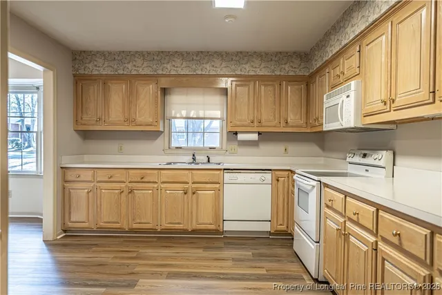 a kitchen with stainless steel appliances granite countertop a sink and cabinets