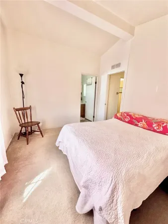 a bedroom with a bed and a mirror