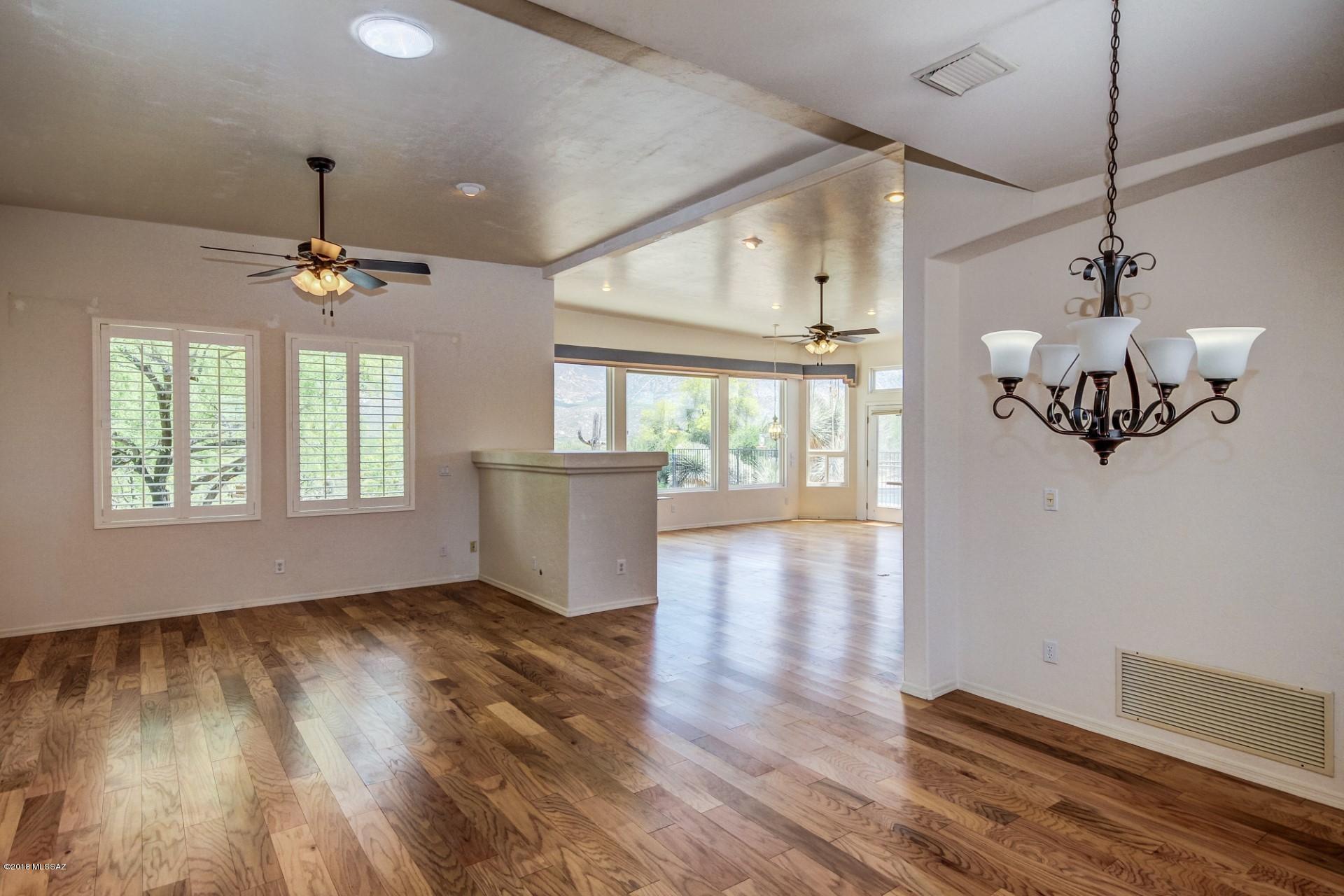 14480 North Swan Road Tucson, AZ 85739 - Photo 5 of 31 a view of an empty room with wooden floor and a window