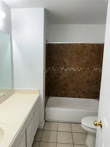 a bathroom with a bathtub and toilet