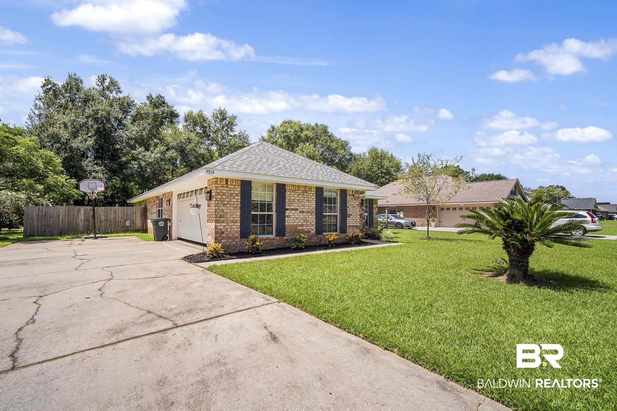 9814 Woolrich Avenue Fairhope, AL 36532 - Photo 2 of 29 Single story home featuring a garage and a front lawn