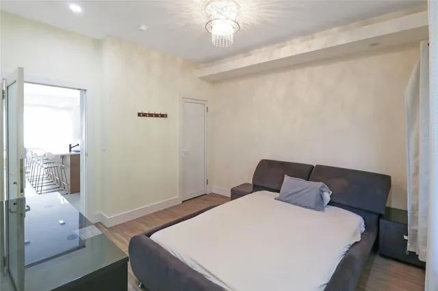 a bedroom with a bed and a window