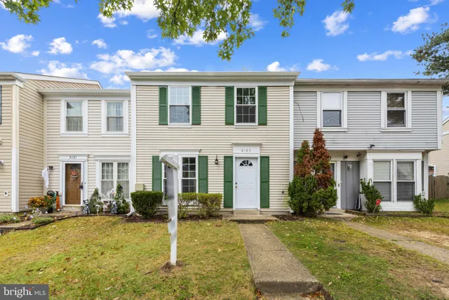 a view of a house with swimming pool and sitting area