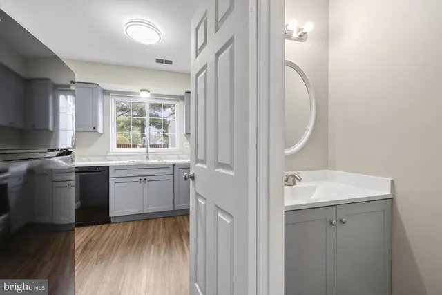 a kitchen with a sink cabinets appliances and a window