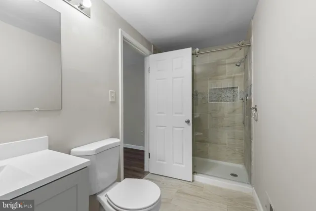 a white toilet sitting next to a bathroom sink
