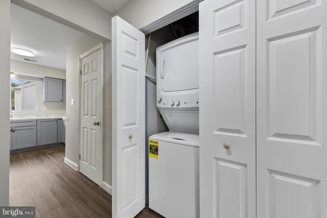 a view of storage and utility room with wooden floor