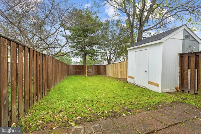 a view of backyard with tub and trees