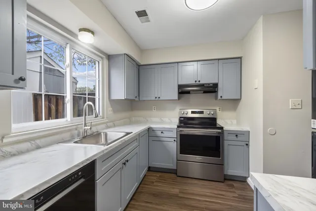 a kitchen with a stove and a sink