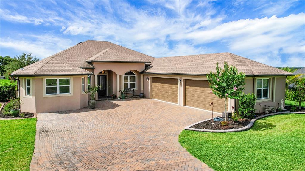 6008 Apex Way Lady Lake, FL 32159 - Photo 1 of 93 a front view of a house with a yard and garage