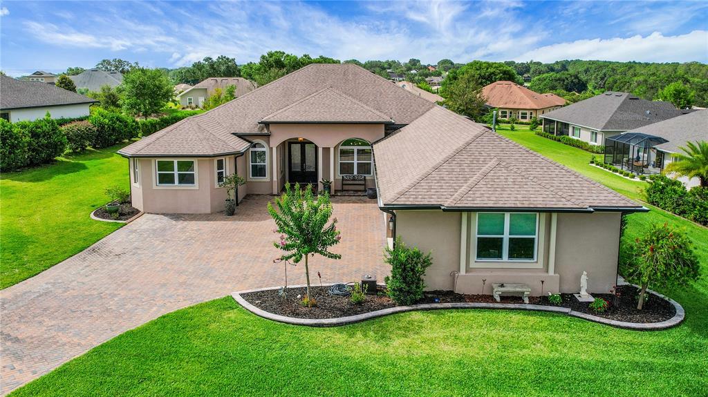 6008 Apex Way Lady Lake, FL 32159 - Photo 2 of 93 a front view of a house with a garden and plants