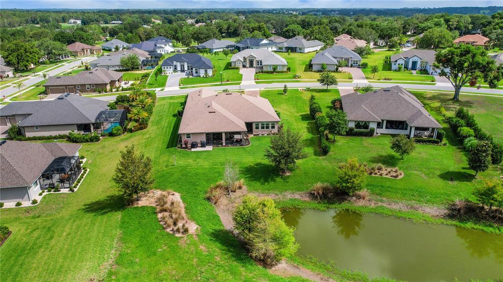 6008 Apex Way Lady Lake, FL 32159 - Photo 3 of 93 an aerial view of residential houses with outdoor space and lake view