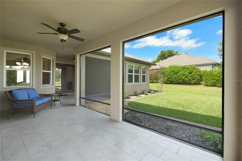 6008 Apex Way Lady Lake, FL 32159 - Photo 46 of 93 a bedroom with furniture and a large window