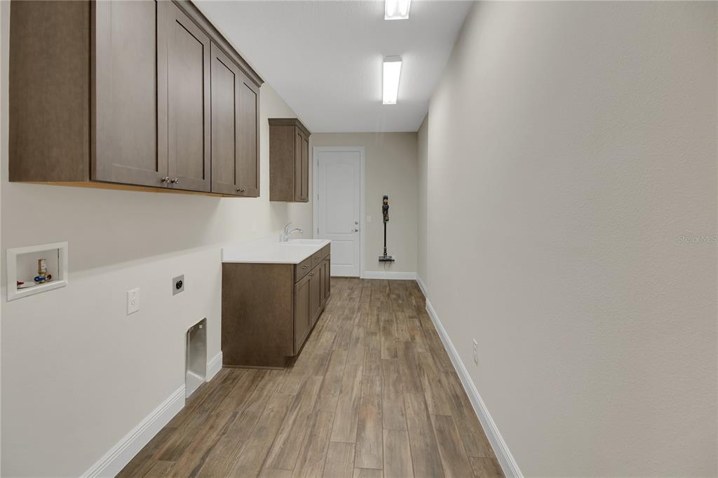 6008 Apex Way Lady Lake, FL 32159 - Photo 55 of 93 a view of a kitchen with wooden floor
