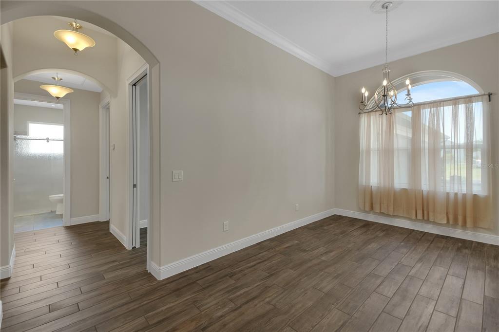 6008 Apex Way Lady Lake, FL 32159 - Photo 61 of 93 an empty room with wooden floor and windows