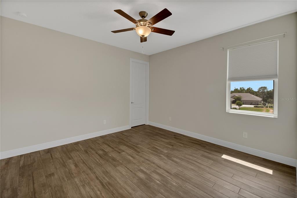 6008 Apex Way Lady Lake, FL 32159 - Photo 62 of 93 wooden floor in an empty room with a window
