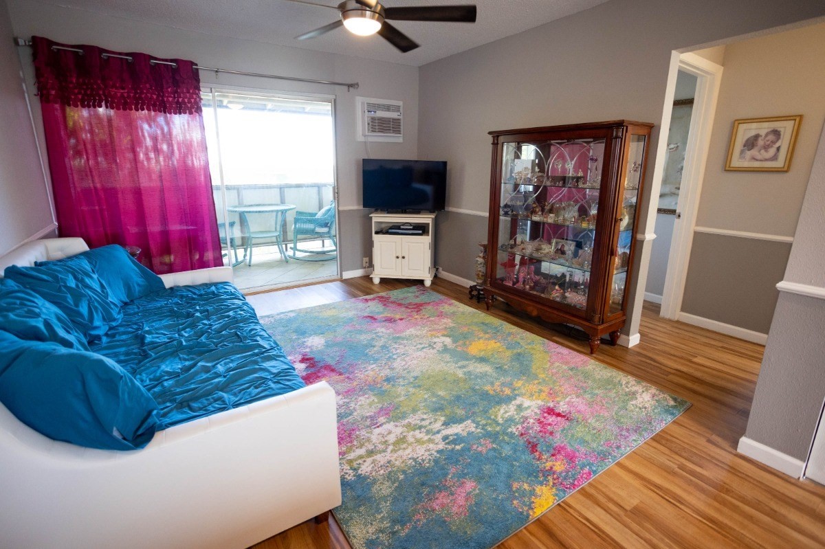 74-5618 Palani Road, Unit C2 Kailua-Kona, HI 96740 - Photo 1 of 8 a living room with furniture and a flat screen tv