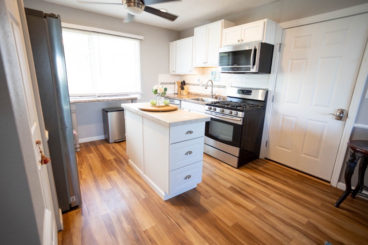 74-5618 Palani Road, Unit C2 Kailua-Kona, HI 96740 - Photo 2 of 8 a kitchen with stainless steel appliances a stove a sink and a refrigerator