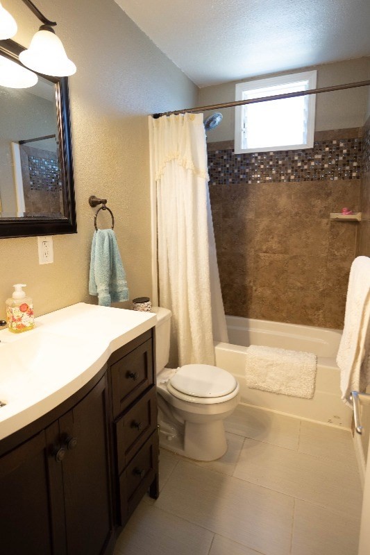 74-5618 Palani Road, Unit C2 Kailua-Kona, HI 96740 - Photo 4 of 8 a bathroom with a granite countertop sink toilet and shower