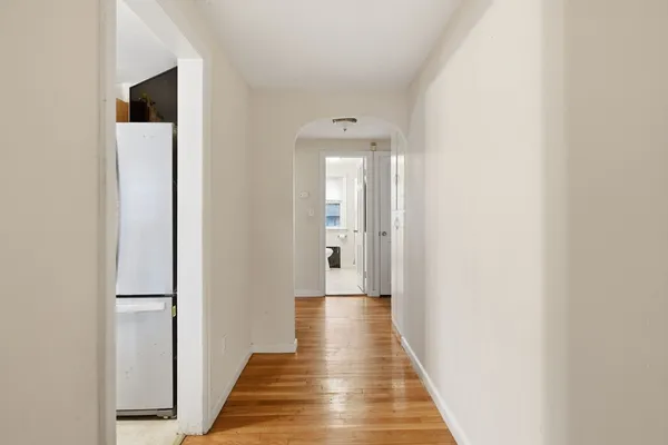 a view of a hallway with wooden floor