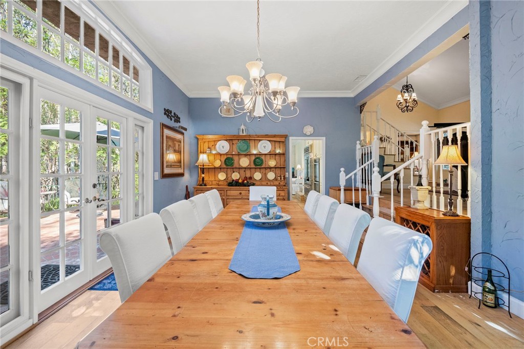 24945 Valley Rim Terrace Lake Forest, CA 92630 - Photo 11 of 52 a living room with furniture a chandelier and a large window