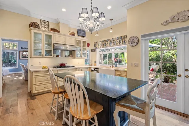 a kitchen with kitchen island a dining table and chairs