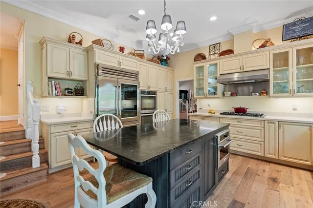 a dining table with chairs and kitchen view