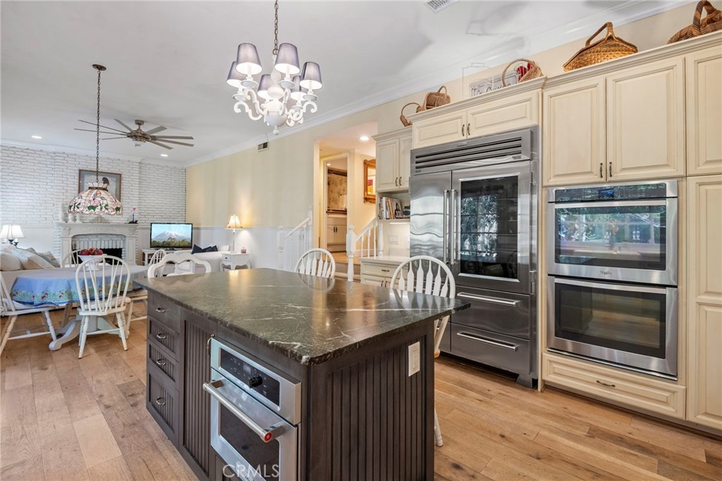 24945 Valley Rim Terrace Lake Forest, CA 92630 - Photo 19 of 52 a dining table with chairs and kitchen view