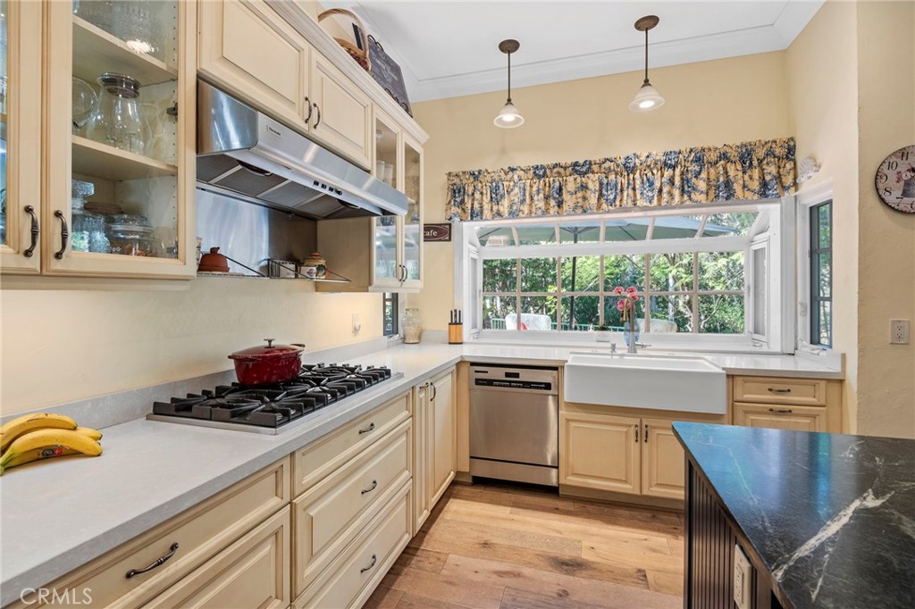 24945 Valley Rim Terrace Lake Forest, CA 92630 - Photo 21 of 52 a kitchen with stainless steel appliances kitchen island granite countertop a stove a sink and a microwave