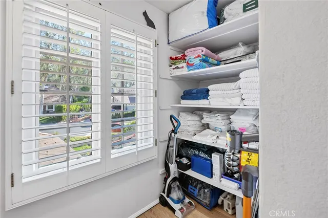 a view of a room with workspace and a window