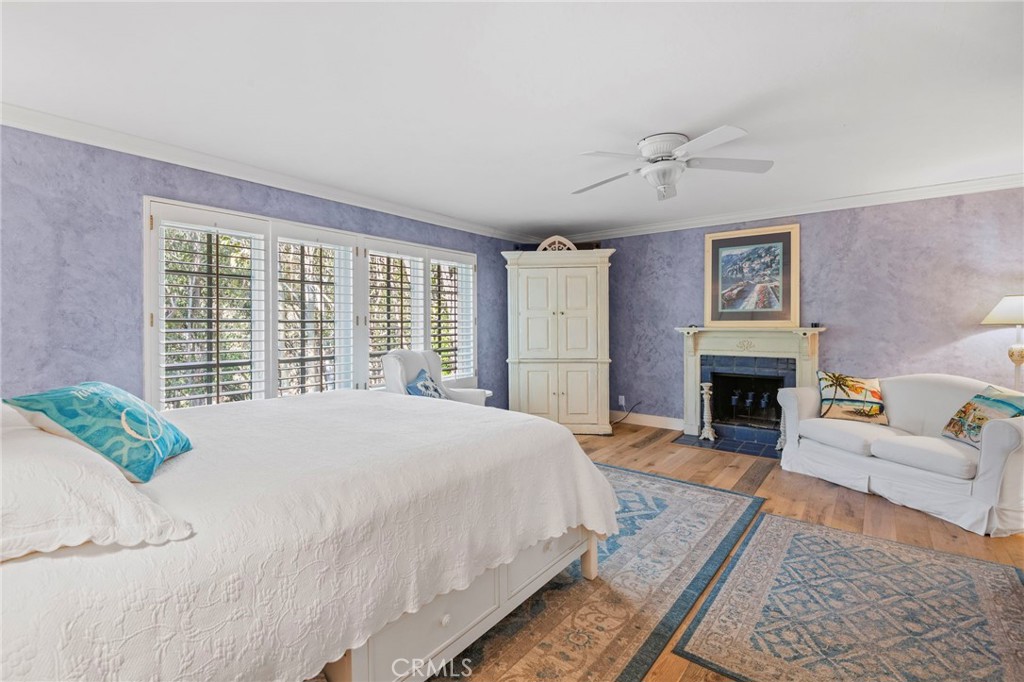 24945 Valley Rim Terrace Lake Forest, CA 92630 - Photo 25 of 52 a spacious bedroom with a bed and a fireplace