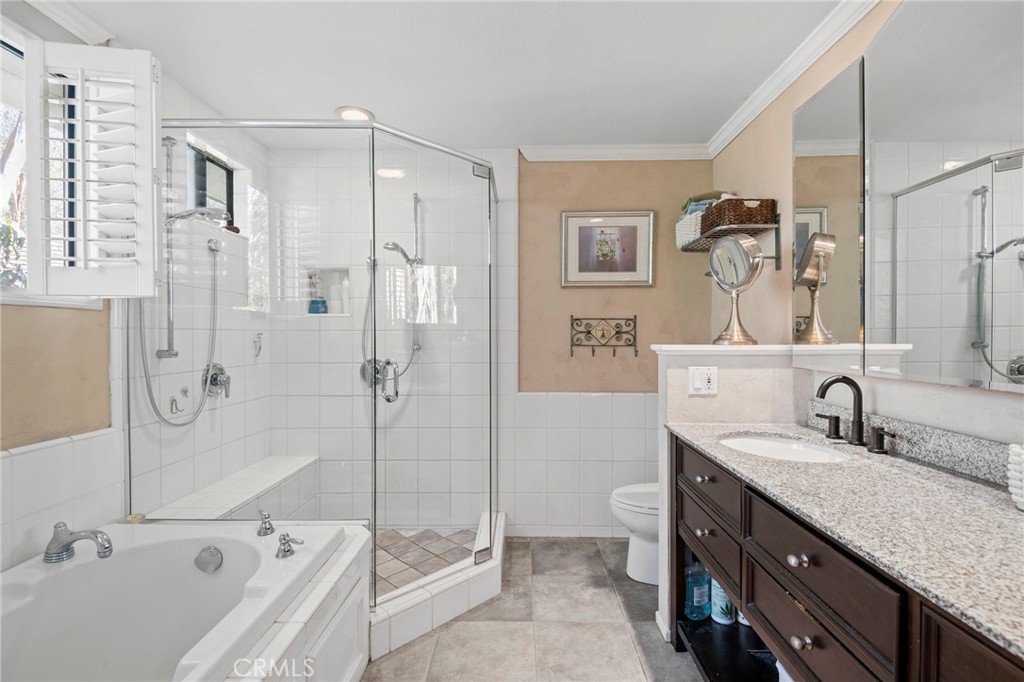 24945 Valley Rim Terrace Lake Forest, CA 92630 - Photo 28 of 52 a bathroom with a granite countertop sink mirror and bathtub