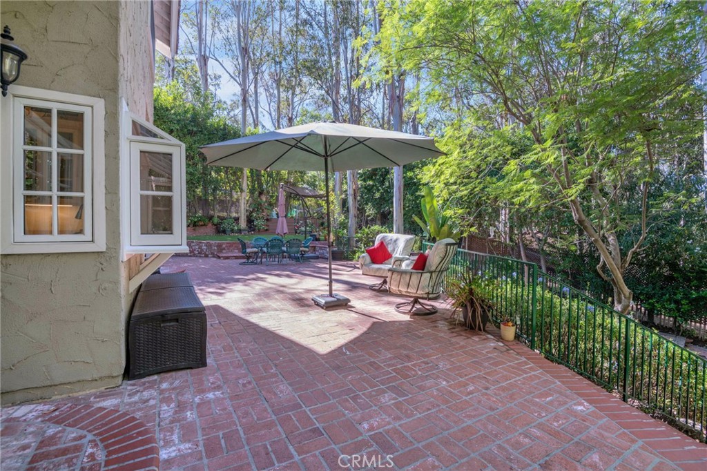 24945 Valley Rim Terrace Lake Forest, CA 92630 - Photo 37 of 52 a view of a patio with a table and chairs under an umbrella