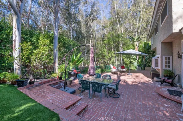 a backyard of a house with flower plants