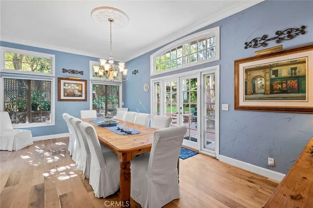 a dining room with wooden floor chandelier