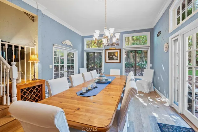 a view of a dining room with furniture wooden floor and chandelier