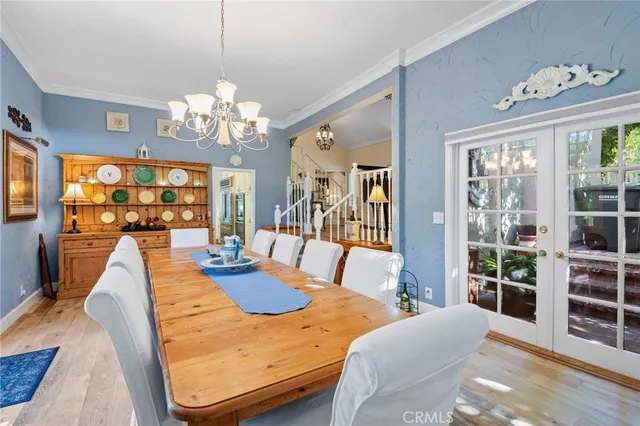 a living room with furniture a chandelier and a large window