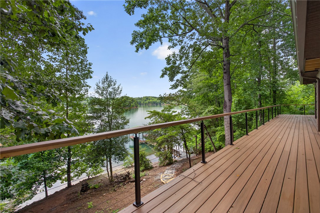 304 Lakeside Drive Seneca, SC 29672 - Photo 44 of 49 An expansive deck provides an inviting outdoor space with lush treeline and tranquil lake views.