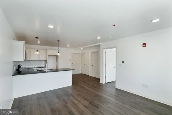 a kitchen with stainless steel appliances a refrigerator and a stove top oven